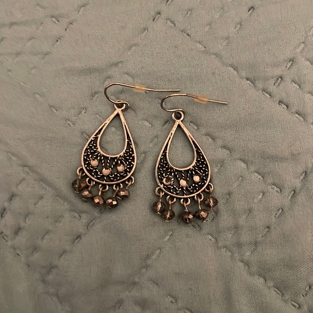 Silver hanging earrings.